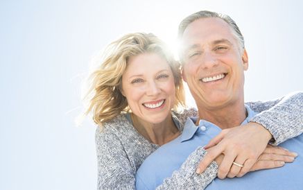 Older couple hugging and smiling